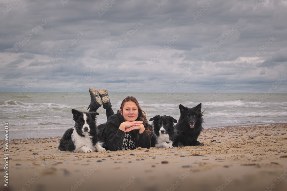 Woman with her dogs near the sea