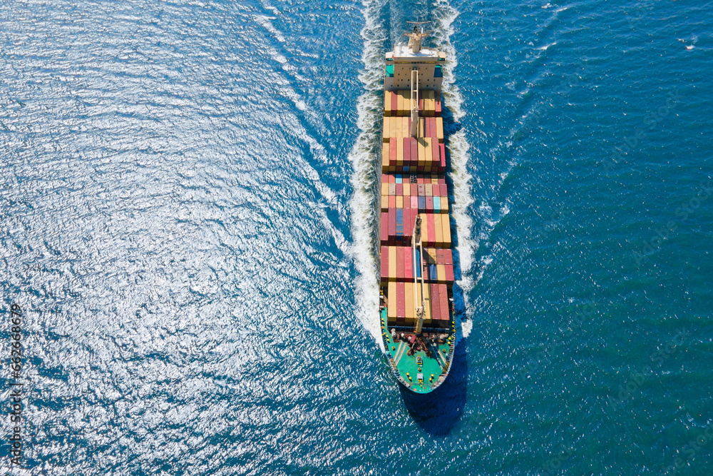 Cargo container ship carrying container and running for export goods from cargo, Aerial shot