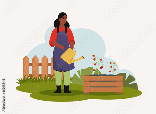 Woman working at garden, watering and gardening