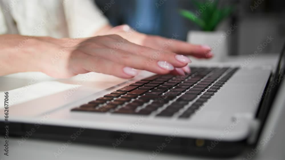 remote work, female worker is typing on a computer keyboard while sitting at a table, close-up remote work, female worker is typing on a computer keyboard while sitting at a table, close-up