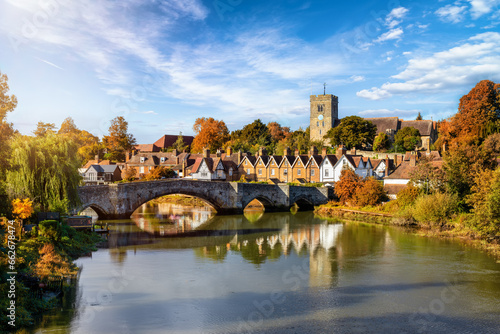 Panoramic view of Aylesford village in Kent, England with medieval bridge over the river Medway during golden autumn time photo