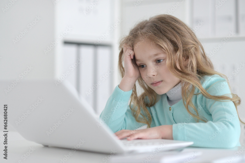 Cute and happy little girl children using laptop computer Cute and happy little girl children using laptop computer