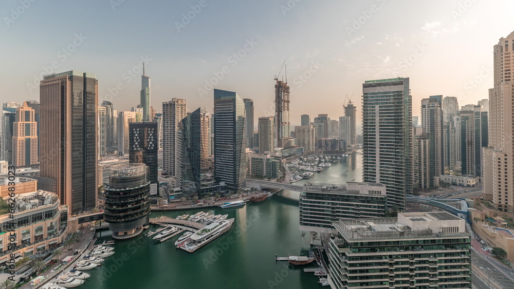 Obraz premium Panorama showing overview to JBR and Dubai Marina skyline with modern high rise skyscrapers waterfront living apartments aerial timelapse