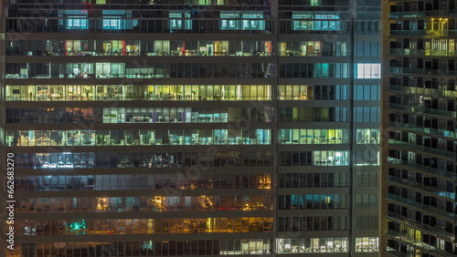 Windows of office buildings at night timelapse  the light from the windows of houses