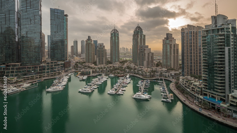 Obraz premium Luxury yacht bay in the city aerial night to day timelapse in Dubai marina