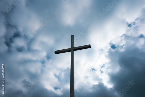 an inverted cross against a cloudy sky