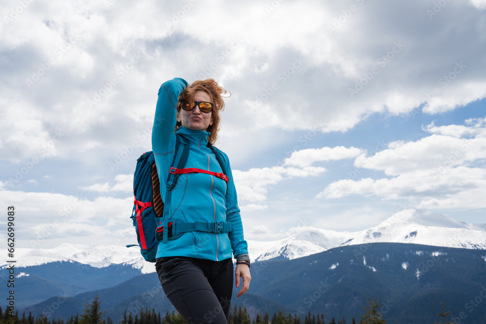 Woman with backpack enjoying the mountain view