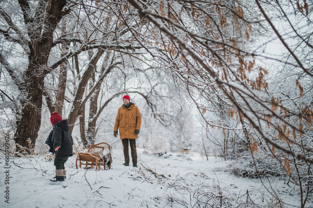Fotka „little boy 23 years old and his father are playing in the snow