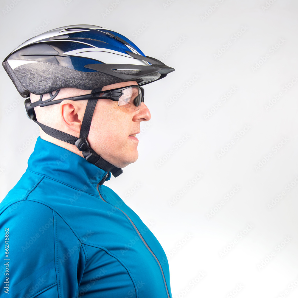 Male cyclist in a bicycle helmet and transparent glasses on a light background Male cyclist in a bicycle helmet and transparent glasses on a light background