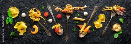 Various pasta forks panorama. Spaghetti, fusilli, penne and other shapes of pasta, with sauce, overhead flat lay shot on a black slate background