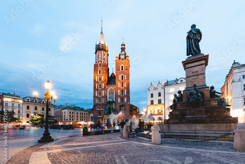 Cracow, Poland old town with St. Mary's Basilica and Adam Mickiewicz monument at the evening photo