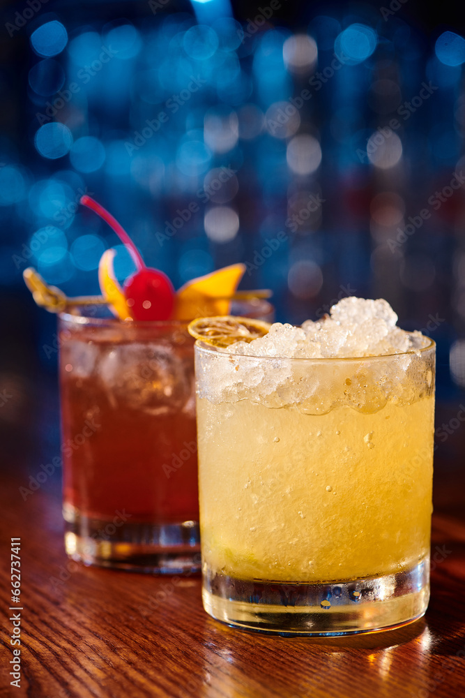 exotic caipirinha and negroni garnished with ice and fruits with bar on backdrop, concept exotic caipirinha and negroni garnished with ice and fruits with bar on backdrop, concept