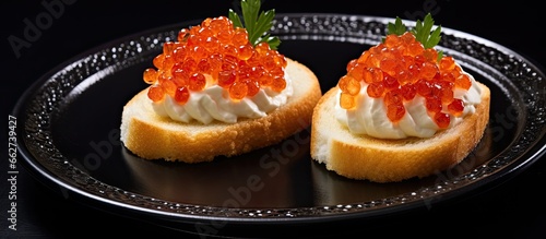 Close up of cheese and red caviar bruschetta on a plate With copyspace for text