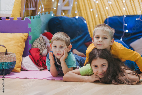 Children play at home with pillows and covered blanket