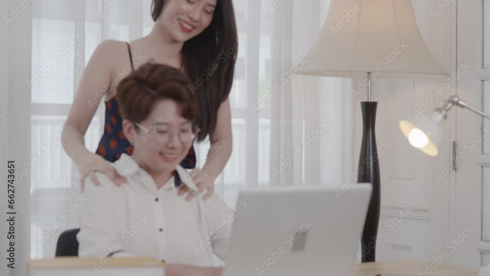 Asian pretty young female lesbian lover with couple partner using laptop computer in living room at home Asian pretty young female lesbian lover with couple partner using laptop computer in living room at home