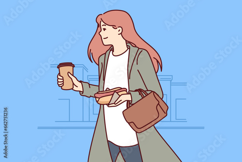 Busy successful woman hurries to work, runs through city streets with hot dog and coffee in hands. Busy positive businesswoman doesnt have time to have breakfast in morning and eats on go