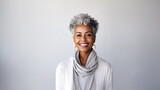 Portrait of beautiful african american woman with grey hair smiling and looking at camera. AI generated