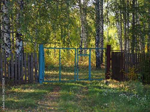 Old Soviet gate. Closed area in the park. Russia, Ural, Perm region, Elovo