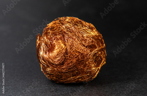 A ball of scrap copper wire on a dark background
