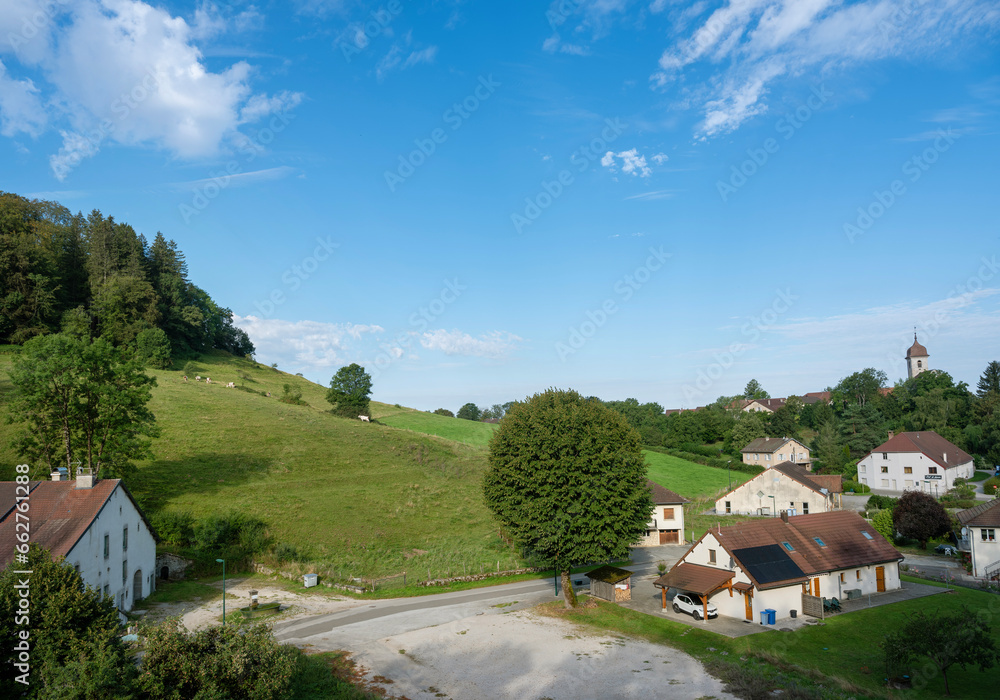 countryside and rolling hills and village in french jura countryside and rolling hills and village in french jura