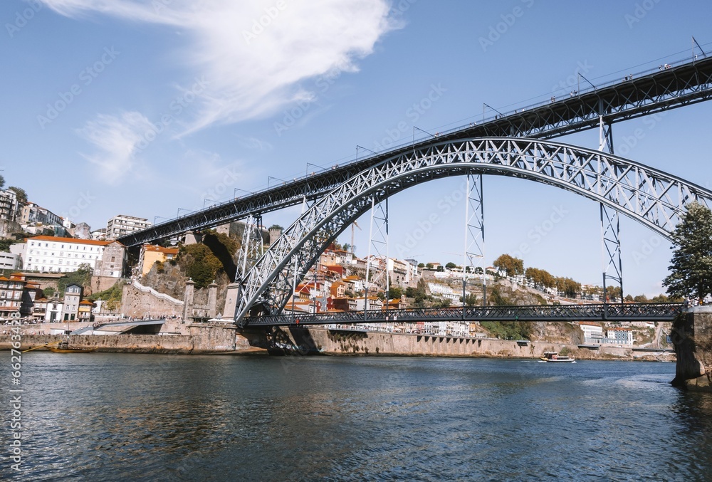 Stunning view of a bridge stretching over a river in the city of Porto, Portugal