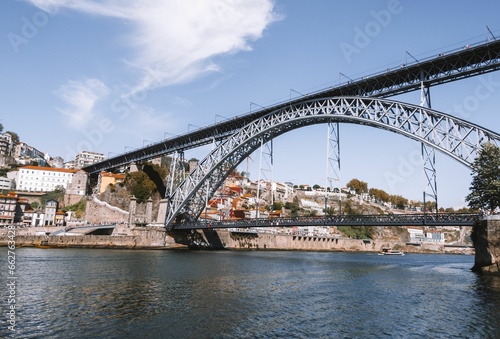 Stunning view of a bridge stretching over a river in the city of Porto, Portugal