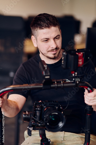 Slika na platnu A professional videographer using modern equipment to capture compelling visuals, showcasing expertise and creativity in the art of video production