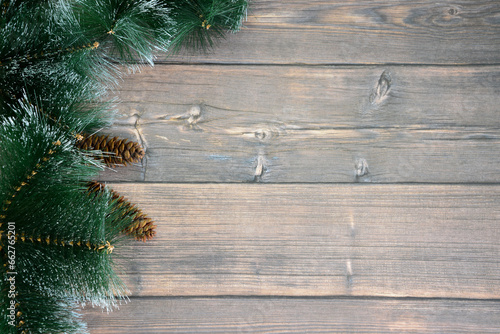 wooden board with copy space decorated with spruce branches and cones 