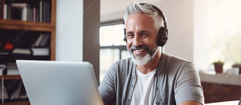 Elderly man teaches university lecture online at home via video call With copyspace for text Elderly man teaches university lecture online at home via video call With copyspace for text