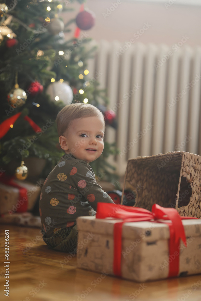 Unwrapping Holiday Happiness: Little Boy's Christmas Excitement Unwrapping Holiday Happiness: Little Boy's Christmas Excitement