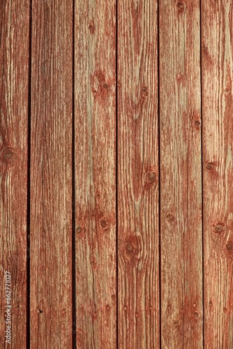 Closeup of vertical red painted wooden plank wall background texture.