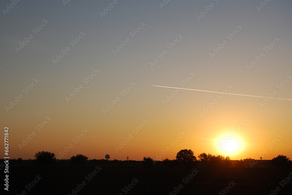 Fototapeta premium Sky, sun, evening and air plane with contrail.