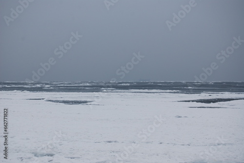Black sea, winter, melancholy.There is a ship in the road stead in the fog. photo