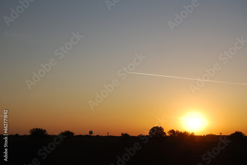 Sky, sun, evening and air plane with contrail.