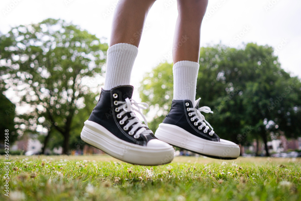 Stylish black sneakers on the grass Stylish black sneakers on the grass