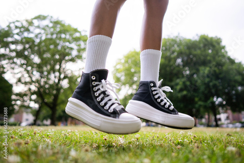 Stylish black sneakers on the grass © Rock and Wasp