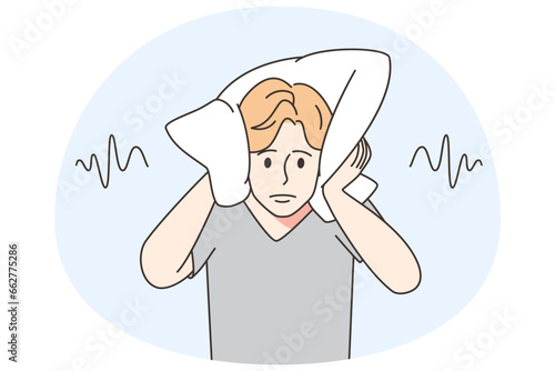 Man cover ears with pillow