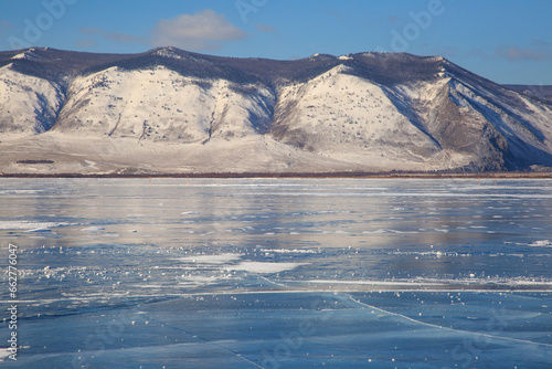 Landscape with mountains and transparent ice of Lake Baikal.