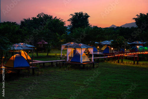 Photos camping tent with tarp or flysheet on grass courtyard and warm night light under