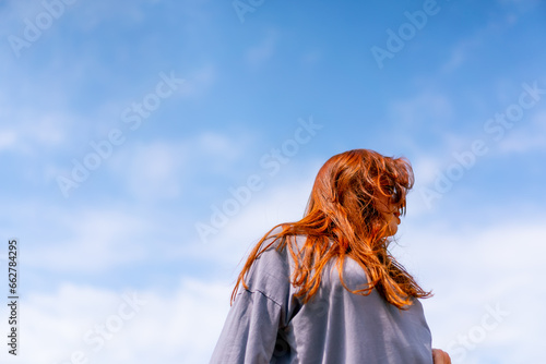 young red-haired street hip-hop dancer in sportswear dances impromptu dance us bridge attract the attention of passers-by hobbies active lifestyle