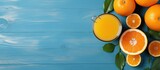 Freshly squeezed orange juice on blue table top from fresh oranges With copyspace for text