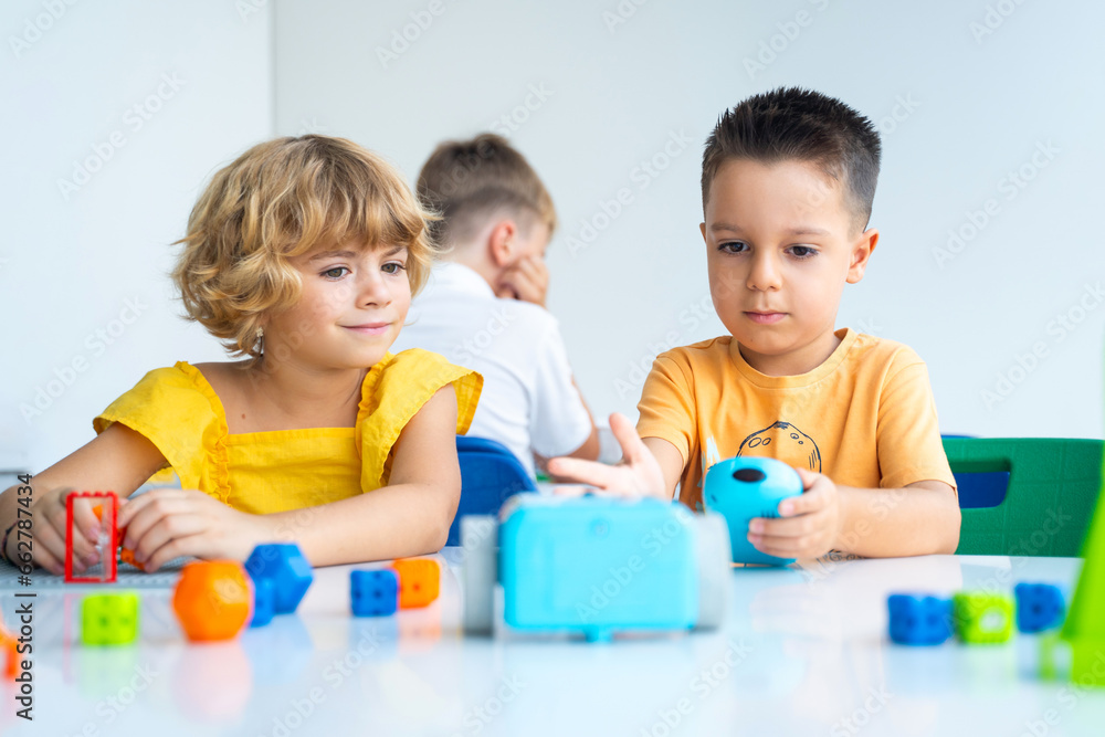 Robotics programming class. Preschool Children construct and code Robot. STEM education using constructor blocks and laptop, remote control joystick. Technology educational development for school kids Robotics programming class. Preschool Children construct and code Robot. STEM education using constructor blocks and laptop, remote control joystick. Technology educational development for school kids