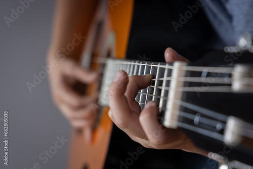 Playing the guitar. Teenager playing guitar. Close up. Lifestyle concept.