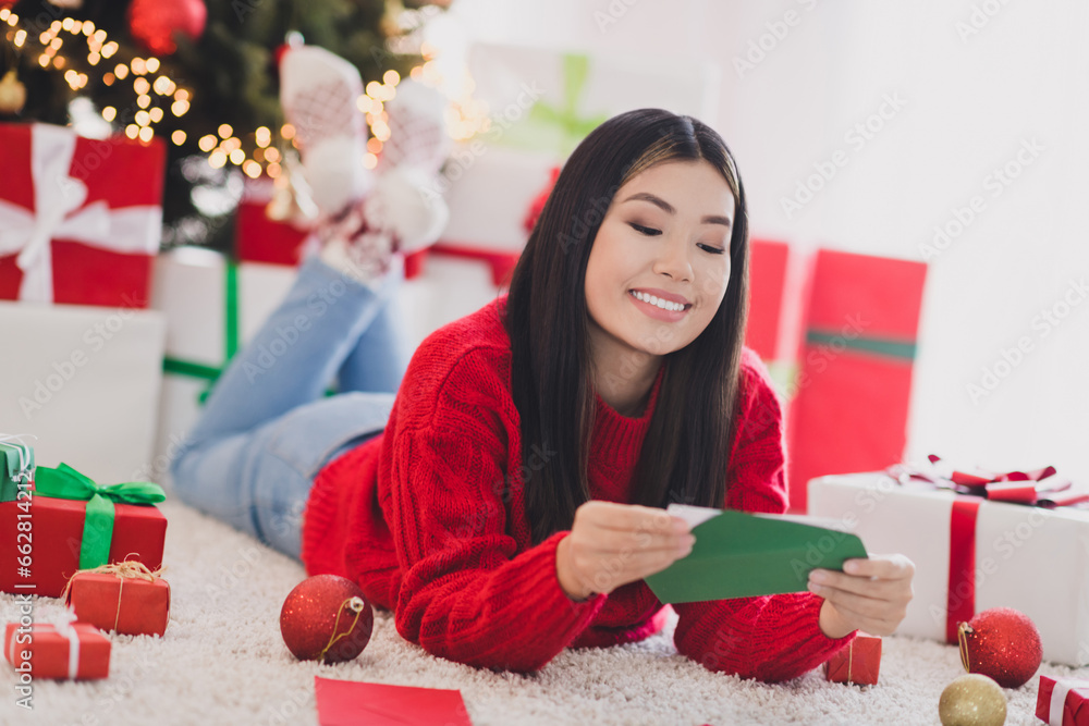Portrait of good mood nice satisfied woman with straight hairdo wear red knit pullover unpacking letter read invitation in house indoors Portrait of good mood nice satisfied woman with straight hairdo wear red knit pullover unpacking letter read invitation in house indoors