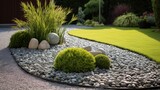 Decorative ground in the garden with artificial grass, gravel and explsed aggregate finish