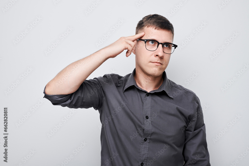 Portrait of clever man in shirt touching head thinks doubts chooses isolated on white studio background with copy space Portrait of clever man in shirt touching head thinks doubts chooses isolated on white studio background with copy space