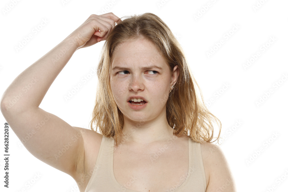 Confused Young Woman Scratching Head On White Background