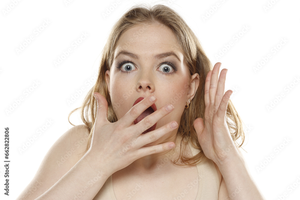 Portrait of young beautiful shocked blonde woman with no makeup on white background Portrait of young beautiful shocked blonde woman with no makeup on white background