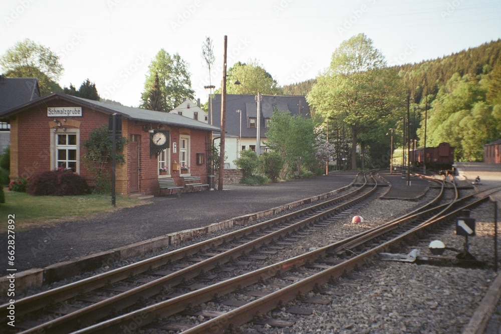 Fototapeta premium Schmalzgrube, Germany - June 03, 2023: view of small train station in Ore mountains - analog