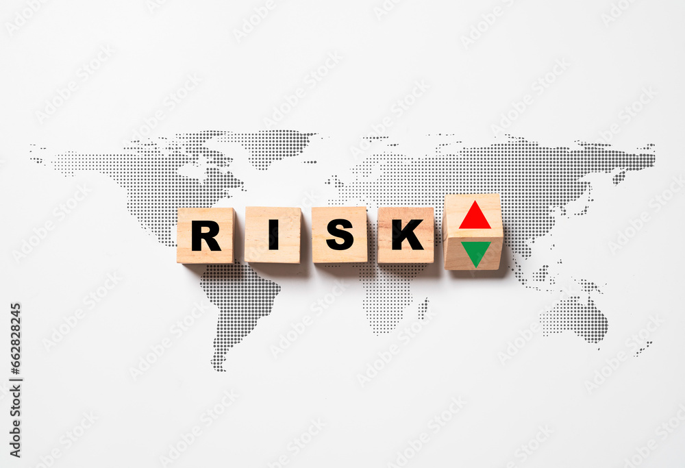 Risk wording with red up arrow and green down arrow on world map for global risk crisis concept.